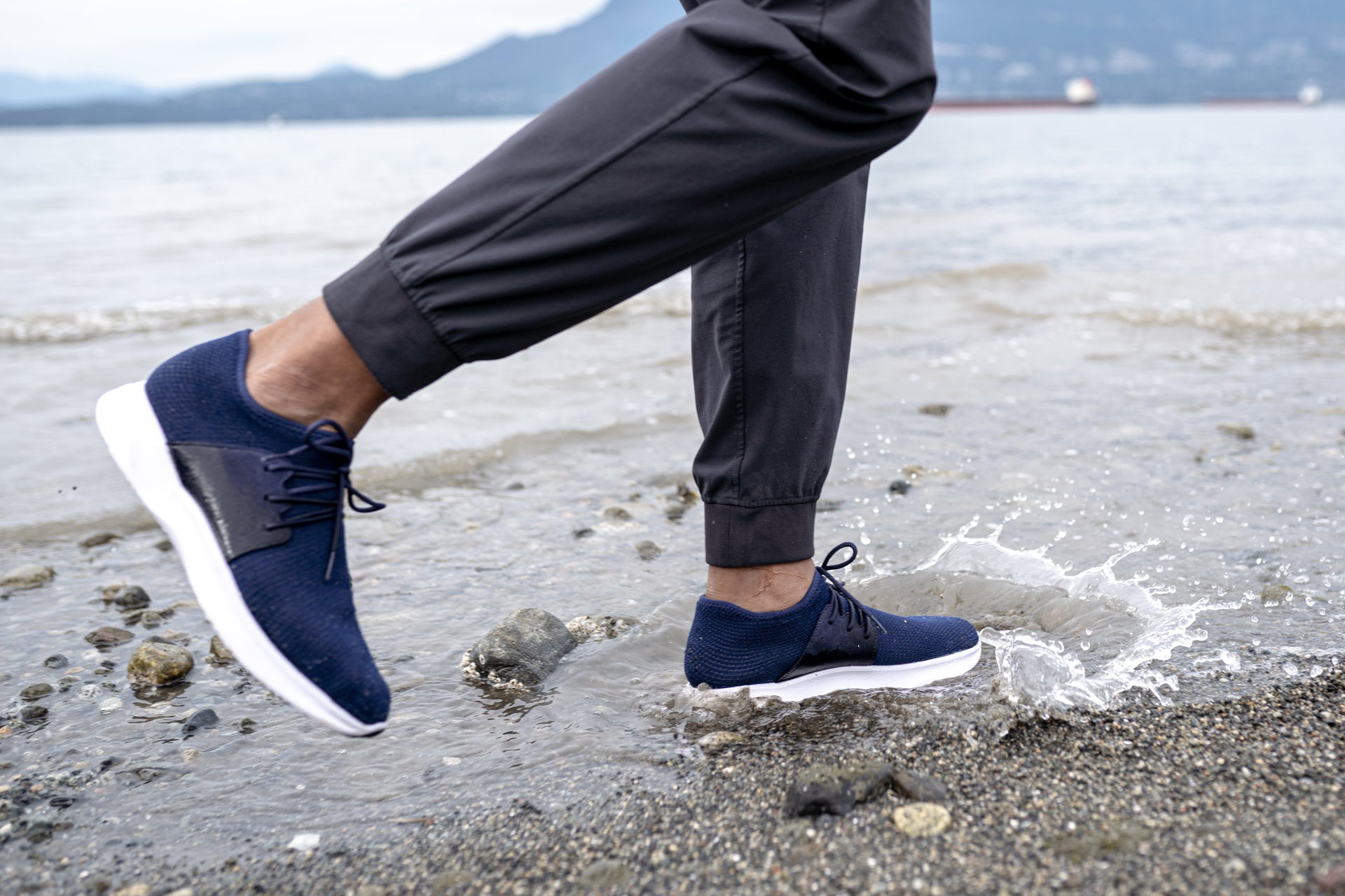 Man at the beach wearing Vessi Everyday Waterproof Shoes