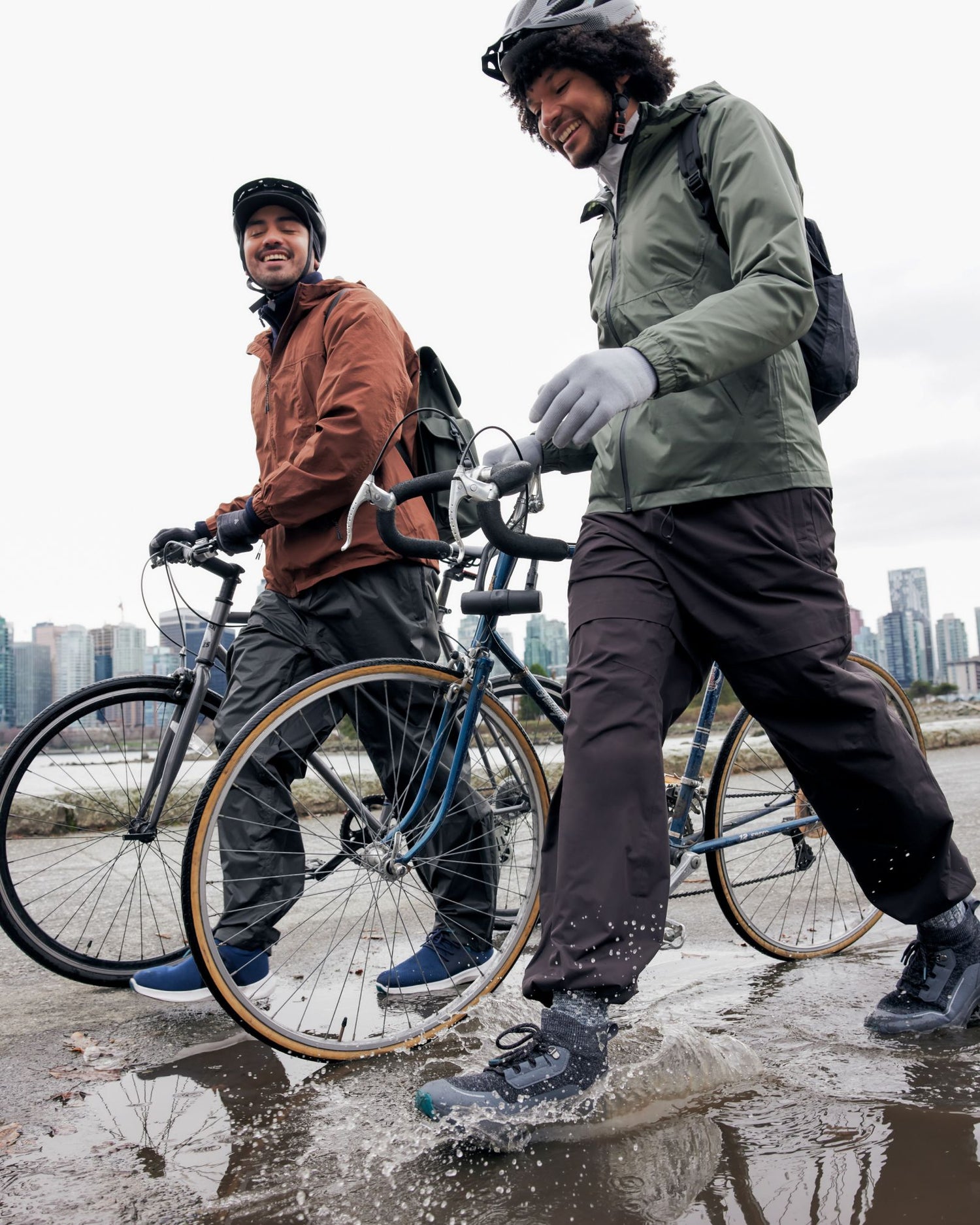 Two carrying their bikes with their Vessi shoes